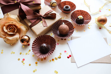 Fototapeta na wymiar christmas gift concept. gift box, set of chocolates and Christmas tree decorations on a white background.