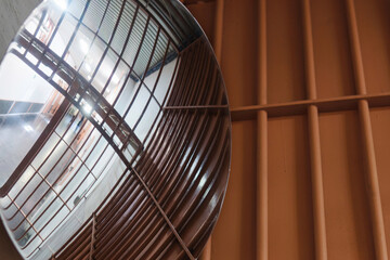 Round panoramic mirror in jail. Controlled access.
