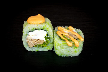 Sushi and rolls on a black