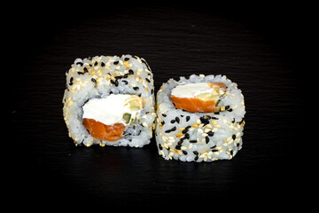 Sushi and rolls on a black