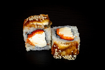 Sushi and rolls on a black