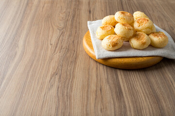 Traditional Brazilian Snack Cheese Bread. On a wooden table background. with copy space