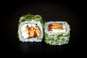 Sushi and rolls on a black