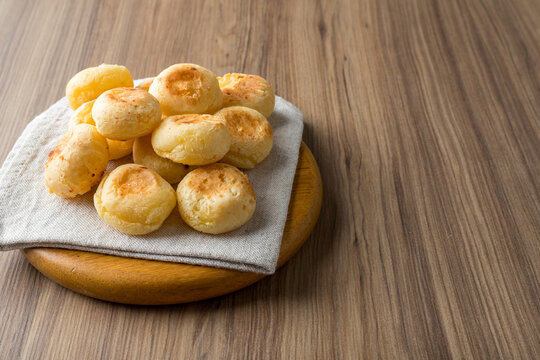 Traditional Brazilian Snack Cheese Bread. On a wooden table background. with copy space