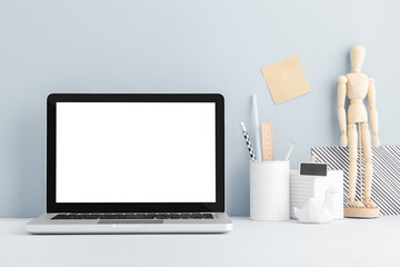 Table with Laptop, notebook, stationery, mannequin on a bright color background. Bloggers...