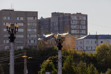 Old stylw light lamps in Ivanovo center with background of buildings, trees, sun shine