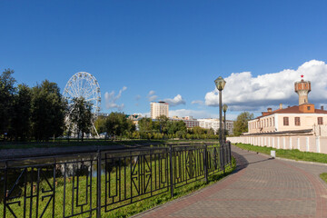 River side embankment in Ivanovo with old factory, Ferris wheel in summer sunny day