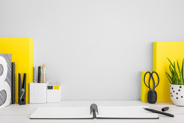Grey workspace and yellow supplies.