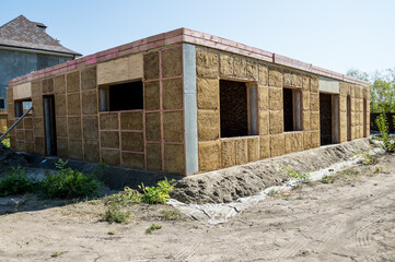 Construction of a house from an environmentally friendly material of plant origin. Frame made of wood, blocks of straw.