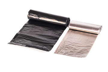 two black garbage bags rolled into a roll. Close-up. Isolate.
