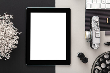 Tablet screen and office supplies, camera, keyboard and coffee. Top view