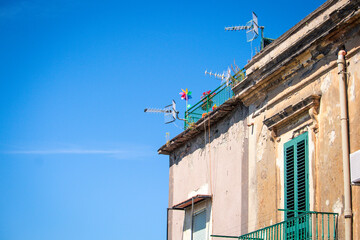 colored Napoli, Italia, windmill on house and blue sky
