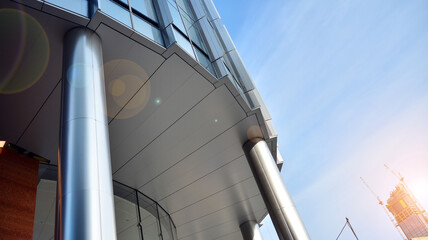 Naklejka premium Office building, details of blue glass wall and sun reflections.