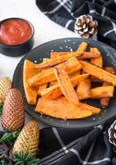 Fried sweet potatoes fries served with Xmas decoration,selective focus