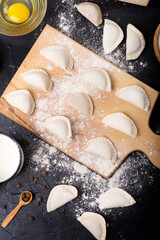 preparing dumplings on a dark table