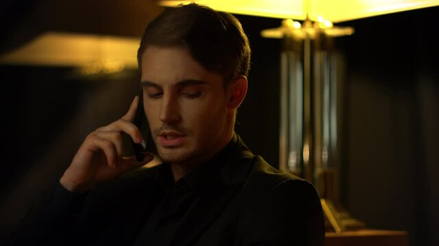 Rich man solving problems on mobile phone indoors. Elegant guy using cellphone.
