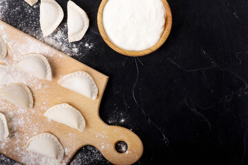 preparing dumplings on a dark table