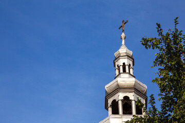 Tower of the church in Polska Cerekiew, blue sky