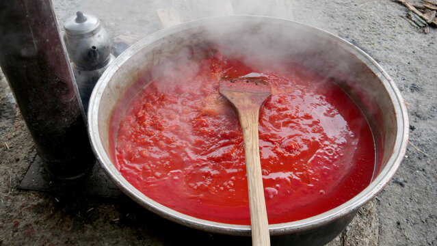 The Tomato Sauce Made With Traditional Methods In Turkey. Natural, Additive-free. In A Copper Pot. It Is Boiling Over Wood Fire.