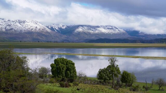 Dramatic clouds over Laguna Terraplen and the snow capped mountains of Los Alerces National Park, Argentina
