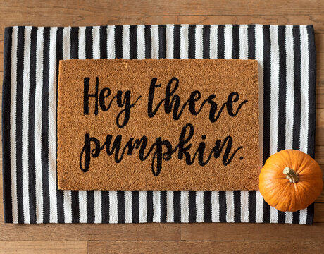 Fall welcome mat and a pumpkin