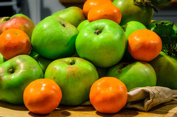 Pile Of Freshly Picked Apples And Oranges On Farmhouse Table 
