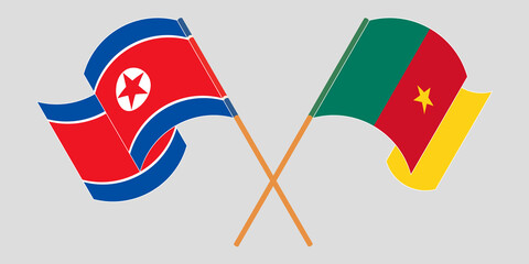 Crossed and waving flags of Cameroon and North Korea