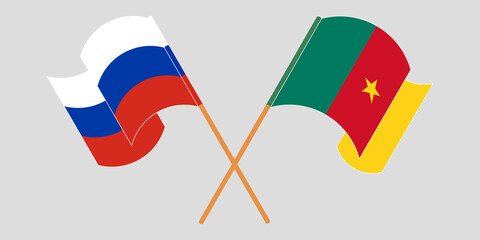 Crossed and waving flags of Cameroon and Russia