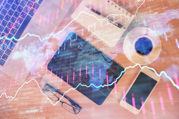 Double exposure of financial graph hologram over desktop with phone. Top view. Mobile trade platform concept.