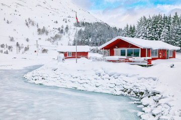 Wonderfull winter scenery with traditional Norwegian red wooden houses on the shore of Rolvsfjord on Vestvagoy island