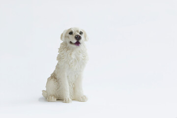 Toy sculpture dog on white background.