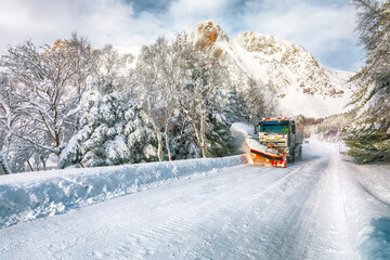 Winter scenery with snowplow truck clearing the road near Valberg © pilat666