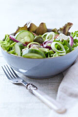 Salad with Green Olives, Cucumber and Feta Cheese. Bright wooden background