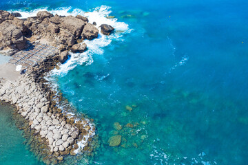 Fototapeta na wymiar Paphos Cyprus beach waves hitting the rocks 