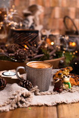 Mug of cocoa with chocolate chip cookies on a wooden table. Christmas drink and biscuit, festive decoration with garlands. Retro photo Happy New Year. High quality photo