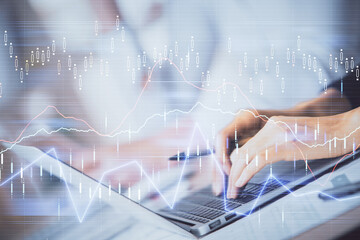 Double exposure of woman hands typing on computer and forex chart hologram drawing. Stock market invest concept.