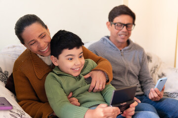 Happy brazilian grandchild with gamepad gaming at family home. Family, affectionate, reunion, together concept.