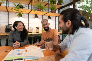 Obraz premium Happy brazilian group of entrepreneurs with big smile discussing sales strategy and planning in office workspace Communication, workspace, meeting concept..