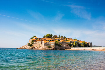 Sveti Stefan island. Luxury resort in Adriatic sea near Budva city, Montenegro. Clear blue sea water around historical town Sveti Stefan.