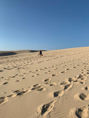 Fototapeta na wymiar Rows of footsteps in the sand of the Pilat dune