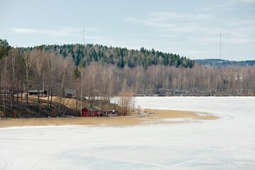 Fototapeta premium Frozen lake landscape in Finland, cold early spring