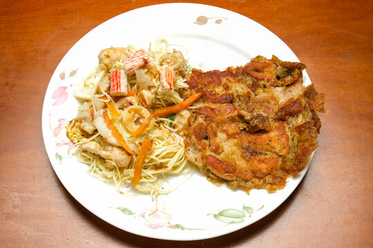 A picture of "mee raja" with chicken chop on the table. "Mee raja" is "misua" fried with special secret recipe.