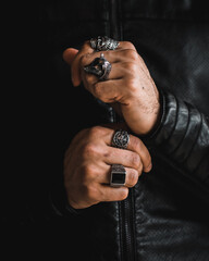 rider man hands wearing rings and leather jacket
