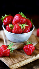 Fresh juicy strawberries in a bowl. Selective focus. Macro.