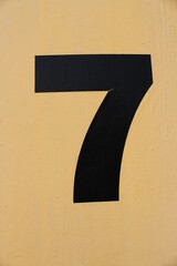 black number 7  on a yellow background
