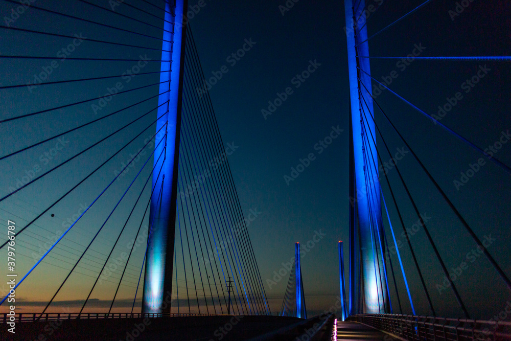 Wall mural steel bridge over waterway evening sky