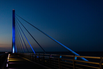 steel bridge over waterway evening sky
