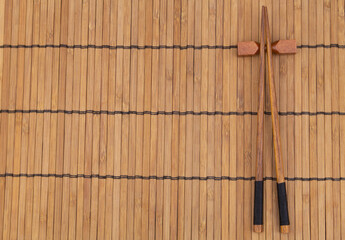 Wooden chopsticks on bamboo place mat with copy space