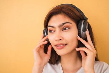 Fototapeta premium Young woman listening music with headphones.