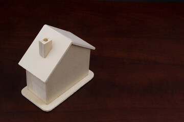 Small wooden house on table with copy space, real estate concept